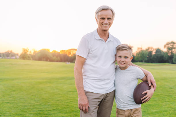 istock grandfather and grandson in park 845813836
