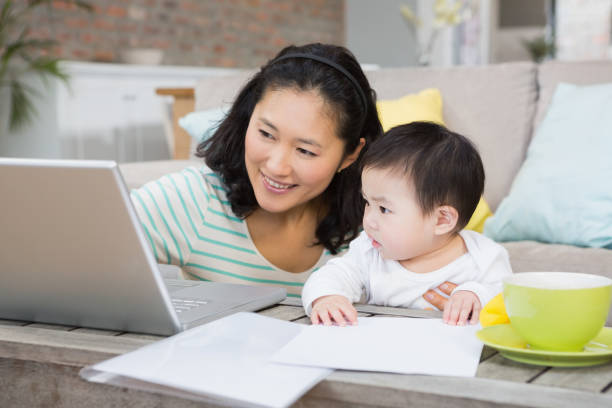 istock Happy mother with baby daughter using laptop 845816896
