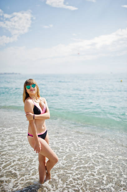 istock Beautiful model relaxing on a beach dressed in a swimsuit. 845828270