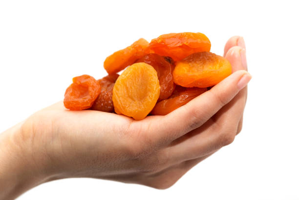 istock dried apricots in a hand on a white background 845828854