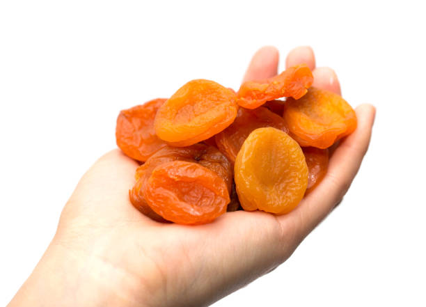 istock dried apricots in a hand on a white background 845828896