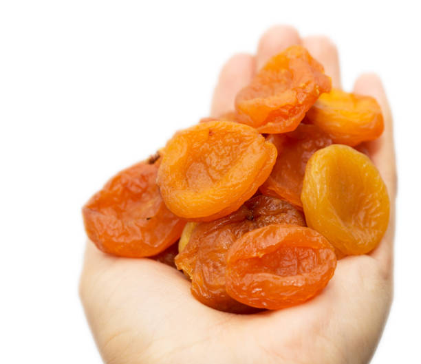 istock dried apricots in a hand on a white background 845828960