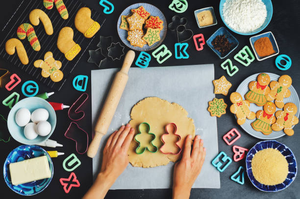 istock Gingerbread cookies with ingredients for baking and woman's hands 845829028