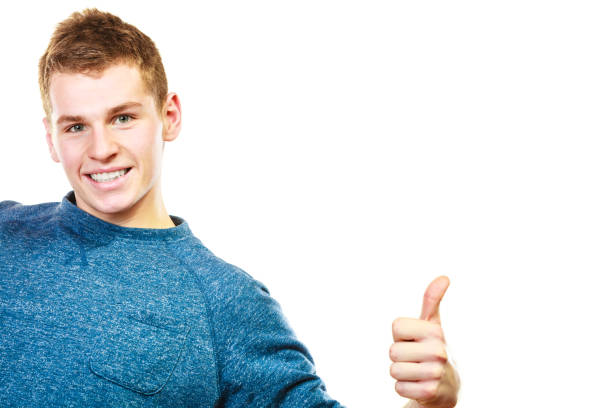 istock Young man showing thumb up hand sign gesture 845829198