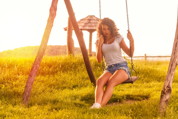 istock Young woman on a swing on a sunny autumn day. 845829332