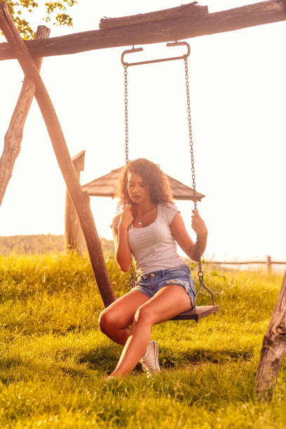 istock Young woman on a swing on a sunny autumn day. 845829442