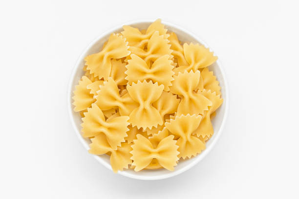 istock Pasta farfalle close-up in white bowl, white background 845830174