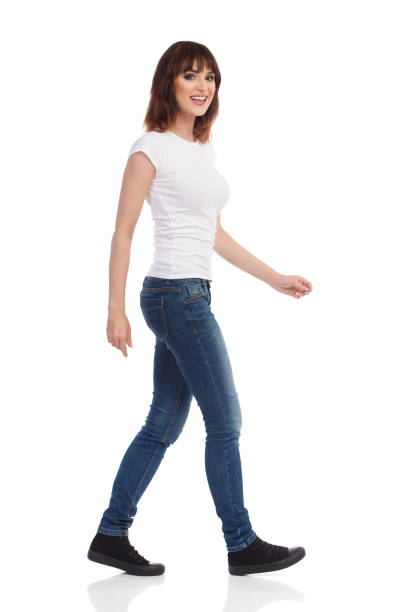 istock Smiling Young Woman Is Walking And Looking At Camera 845836436