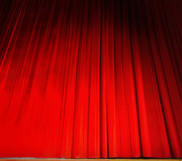istock Red velvet draped stage curtain as background 845836620