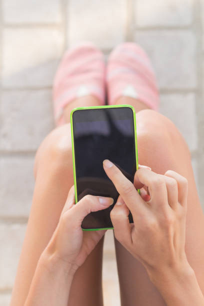 istock Girl texting while sitting on the bench outdoors. 845844642