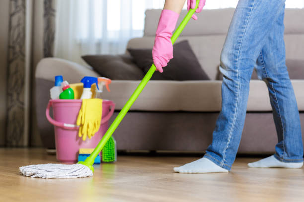 istock woman in protective gloves using a wet-mop while cleaning floor 845847762