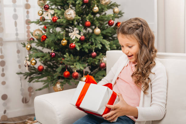 istock little girl with christmas gift 845851554