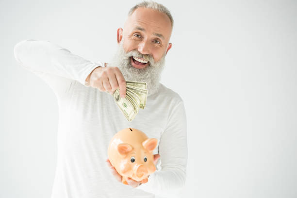 istock man with dollars and piggy bank 845852108
