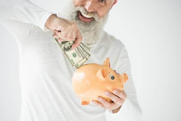 istock man with dollars and piggy bank 845854930