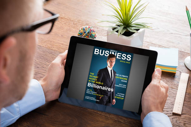 istock Businessman Reading Online Magazine 845855862