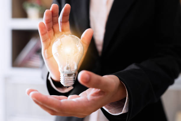 istock Businesswoman holding light bulb. 845856116