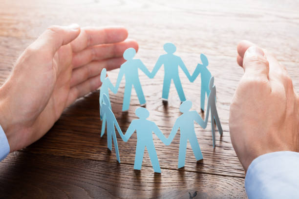 istock Businessperson Protecting Cut-out Figures 845856124
