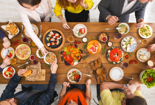 istock People eat healthy meals at served table dinner party 845859368