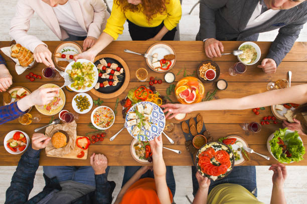 istock People eat healthy meals at served table dinner party 845859468