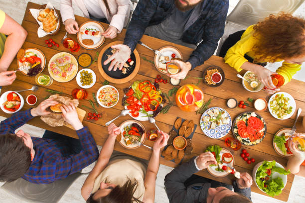 istock People eat healthy meals at served table dinner party 845859578