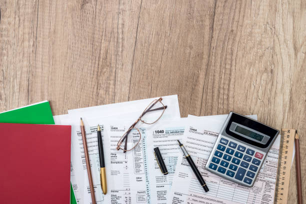 istock tax form with notepad, pen, pencil and calculator 845859886
