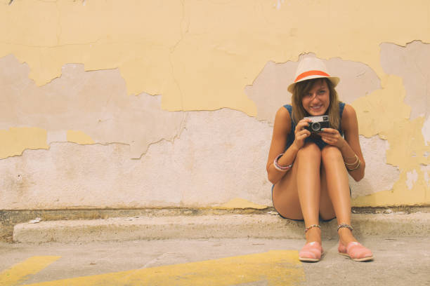istock Cute girl posing outdoors with retro film camera. 845860496