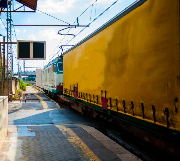 istock passing freight train at a small station pulled by a locomotive 845863600