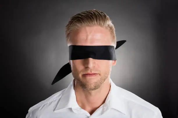 Young Lost Businessman With A Black Blindfold
