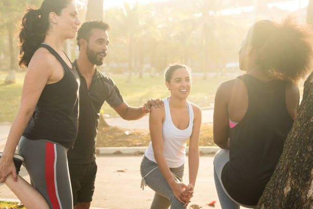 istock friends doing stretching exercises at park during sunny day 845869828