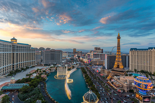 Sunset time high-angle view of the Las Vegas strip featuring the Eiffel tower replica and the fountains of Bellagio as well as the resort hotels Bellagio, Paris-Las Vegas, Ballys and Caesars Palace.
