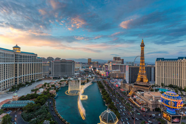 Cityscape Las Vegas Skyline at Sunset Sunset time high-angle view of the Las Vegas strip featuring the Eiffel tower replica and the fountains of Bellagio as well as the resort hotels Bellagio, Paris-Las Vegas, Ballys and Caesars Palace. bellagio stock pictures, royalty-free photos & images