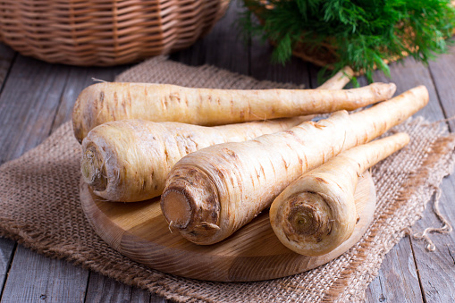Fresh parsnip on wooden table