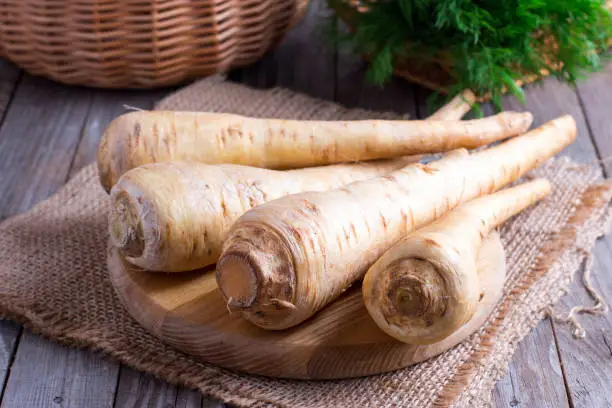 Photo of Fresh parsnip on wooden table