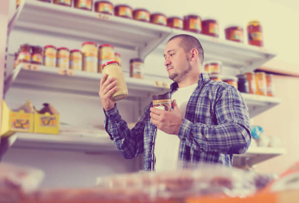istock Man purchasing peanut butter in grocery 845873210