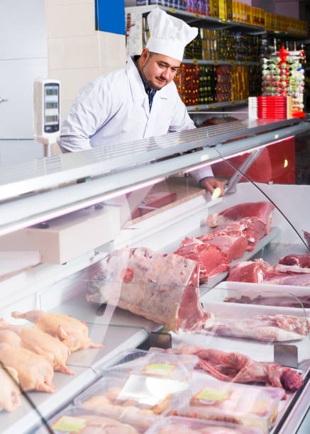 istock Butcher cutting fresh lamb meat 845873222