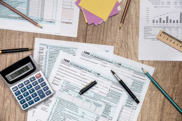 istock saving concept - tax form, budget, notepad, pen, calculator 845873282