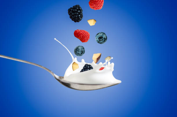 istock Fresh Raspberry, blueberries splashing into milk or yogurt 845873456