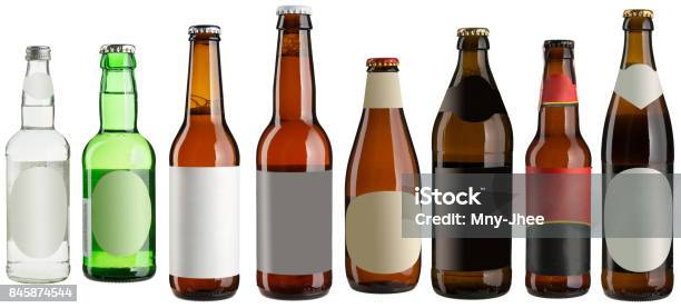 Set Of Multiple Beer Bottles With Blank Stickers Isolated On White Stock Photo - Download Image Now