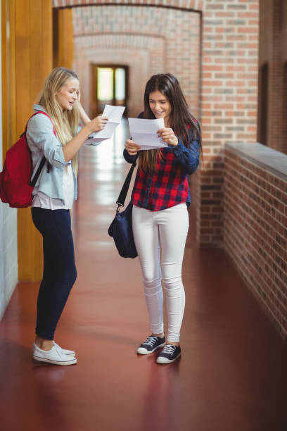 istock Happy female students looking at results 845876864