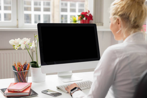 istock Woman in office working on stationary computer 845877818