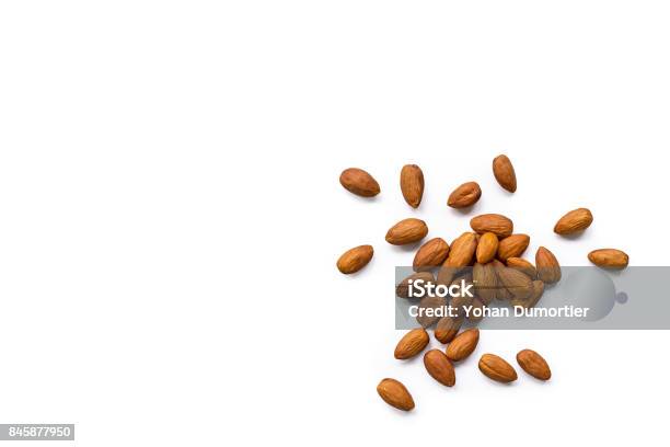 Beautiful Pile Of Roasted Organic Almonds With The Peel Isolated On A White Background Stock Photo - Download Image Now