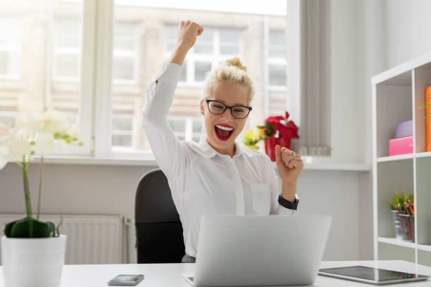 istock Business woman celebrating with hands up 845878046
