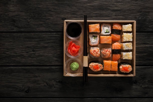 istock Set of sushi maki and rolls at black rustic wood. 845878642
