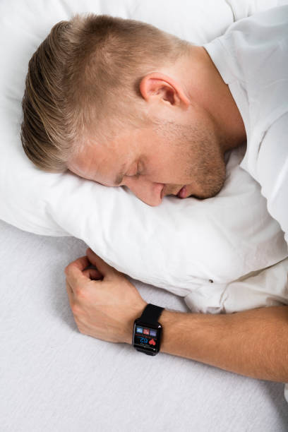 istock Man Sleeping With Smart Watch In His Hand 845885320