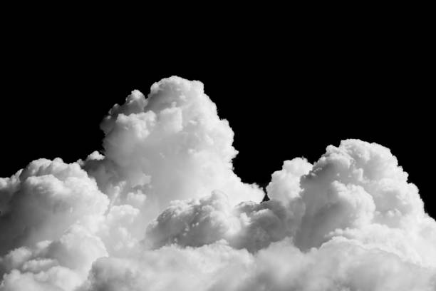 Photo of Close-up cumulus clouds isolated on black background, Black sky with white clouds