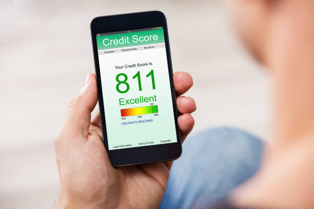 Smart Phone Showing Credit Score On A Screen Man Holding Smart Phone Showing Credit Score Application On A Screen credit score photos stock pictures, royalty-free photos & images