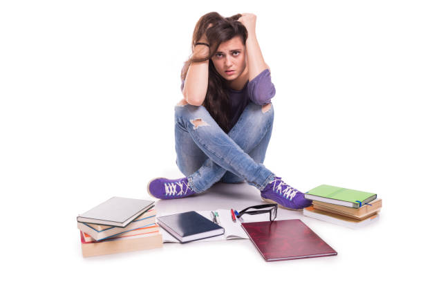 istock Tired and stressed girl surrounded by books 845893274