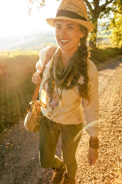 istock happy active woman hiker in hat on Tuscany hike 845896196