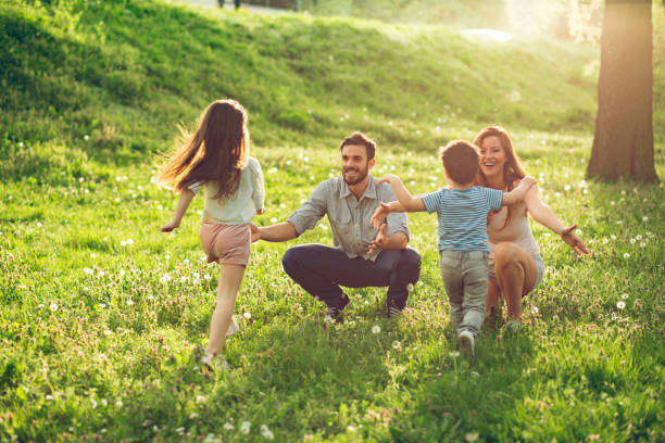 istock Two kids running to their parents in park. 845900248