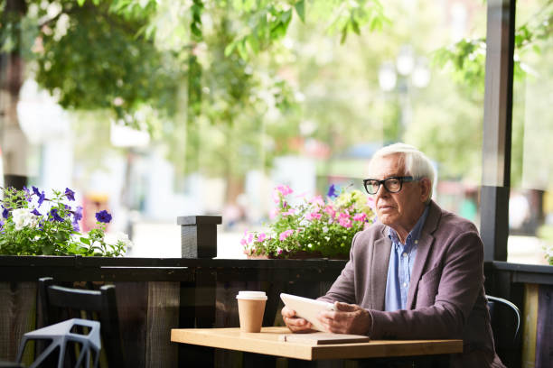 istock Pensive Senior Man in Cafe Outdoors 845900470